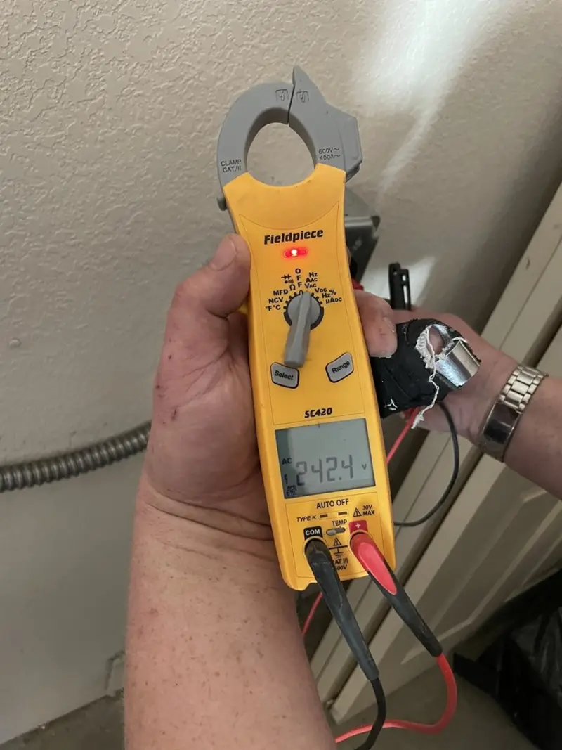 Voltage testing with clamp meter during Electrical Installation Services in Angels